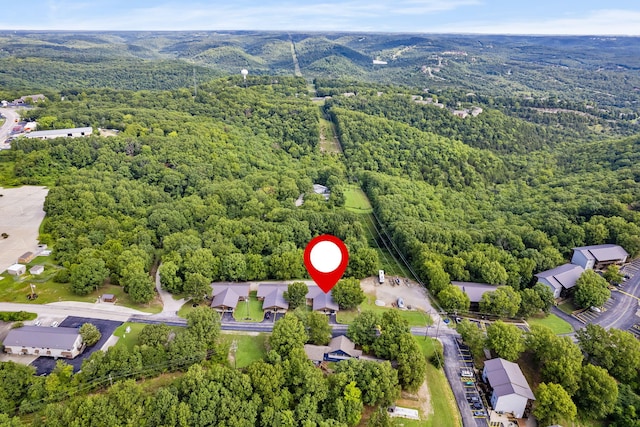 drone / aerial view with a wooded view