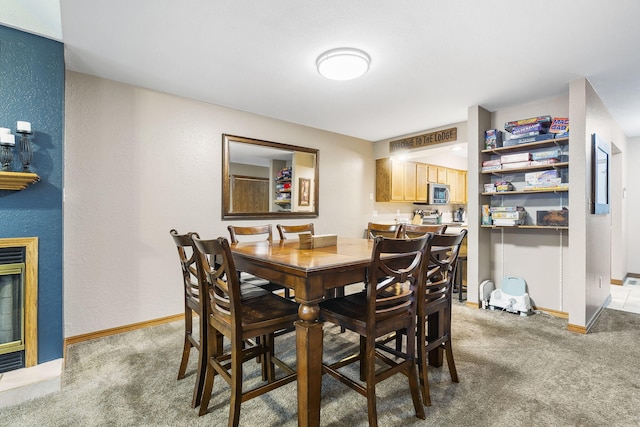 dining area featuring carpet floors and baseboards