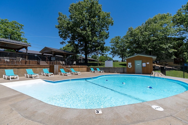 community pool featuring a patio and fence