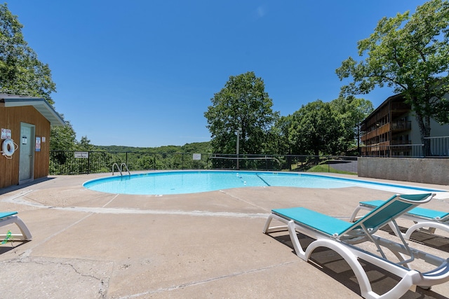 view of swimming pool featuring a patio area