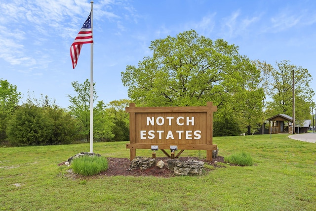 community / neighborhood sign with a lawn