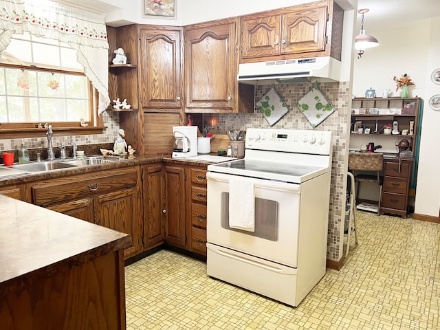 kitchen with tasteful backsplash, decorative light fixtures, sink, and electric range