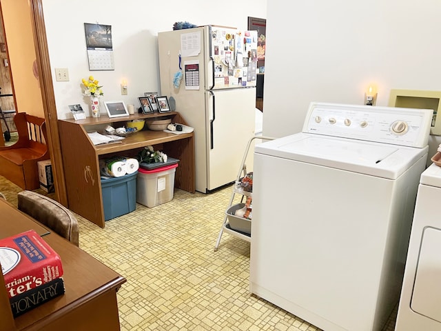 clothes washing area with washer and clothes dryer