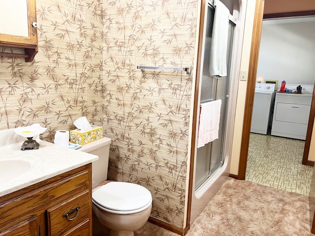 bathroom featuring walk in shower, washer and dryer, vanity, and toilet