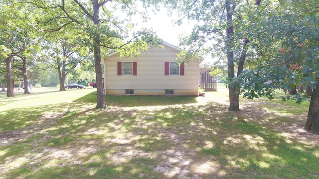 view of side of property with a yard