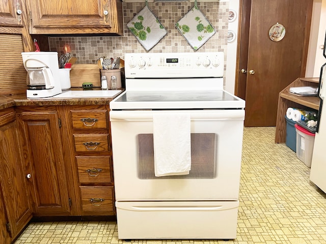 kitchen with backsplash and white electric range