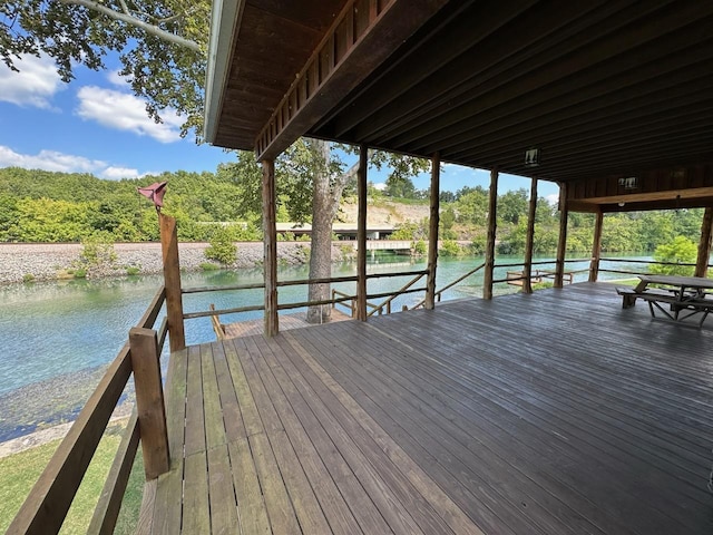 view of dock with a deck with water view