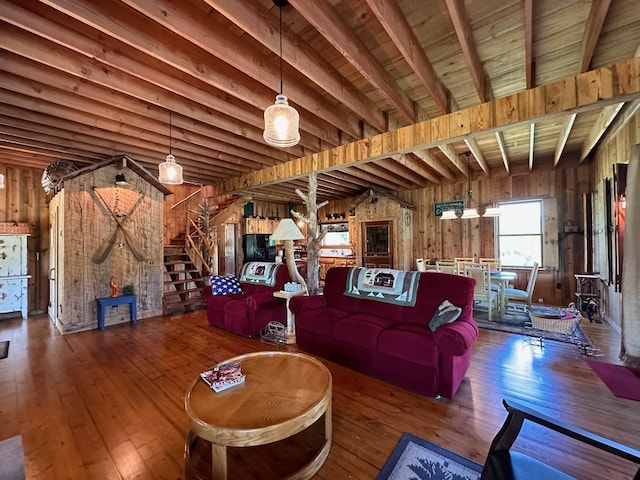 unfurnished living room featuring beamed ceiling, wood walls, wood ceiling, and dark hardwood / wood-style flooring