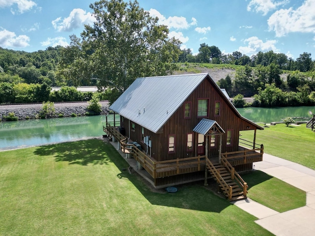 exterior space featuring a front yard, a boat dock, and a water view