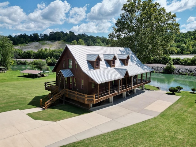 view of front facade featuring a front lawn and a water view