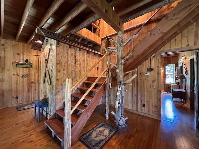 staircase featuring hardwood / wood-style flooring and wooden walls