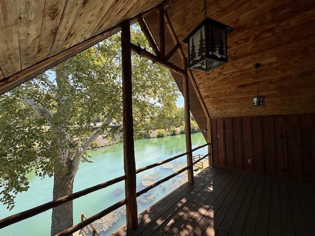 wooden terrace featuring a water view