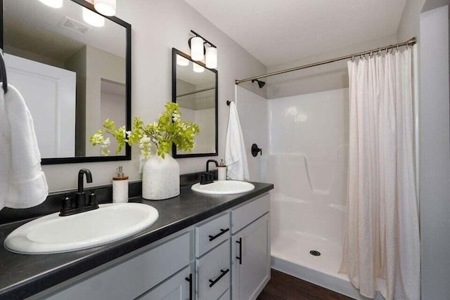 bathroom featuring hardwood / wood-style flooring, vanity, and a shower with curtain