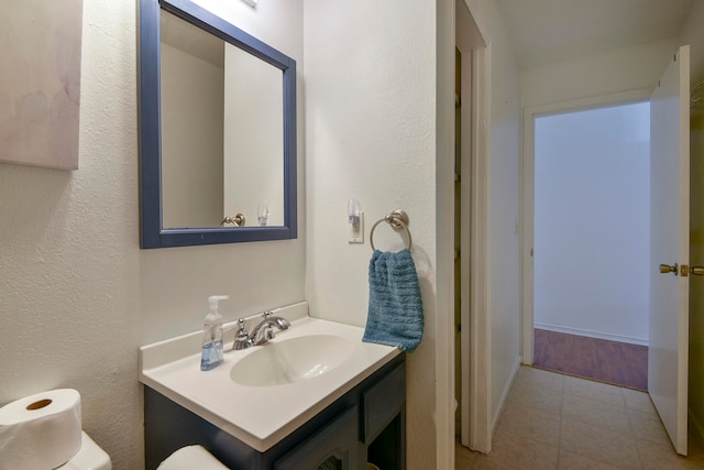 bathroom with vanity, toilet, and tile patterned floors