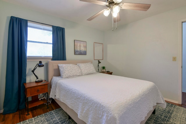 bedroom with ceiling fan and dark hardwood / wood-style flooring