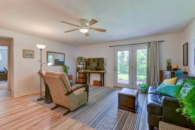 living room featuring ceiling fan and light hardwood / wood-style flooring