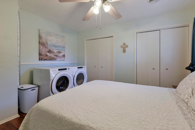 bedroom with independent washer and dryer, dark hardwood / wood-style floors, multiple closets, and ceiling fan