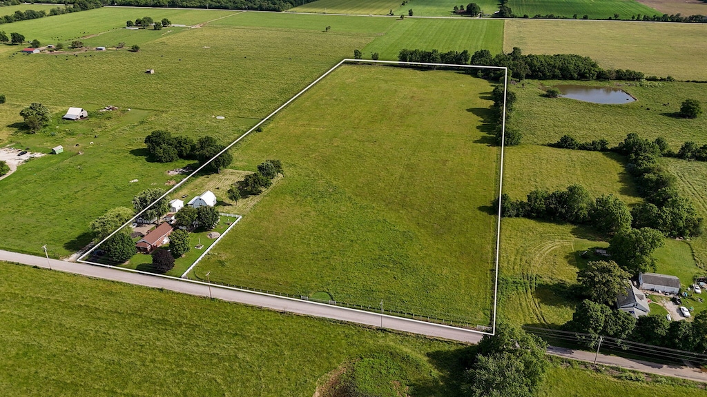 bird's eye view featuring a water view and a rural view