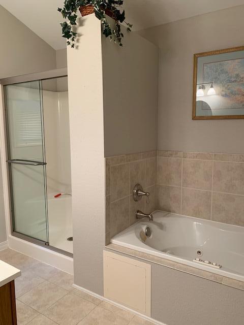 bathroom featuring vanity, shower with separate bathtub, and tile patterned flooring