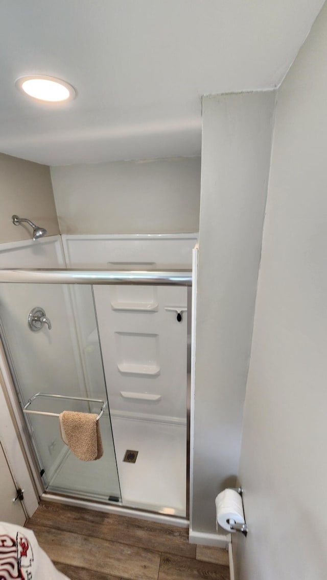 bathroom featuring hardwood / wood-style floors and walk in shower