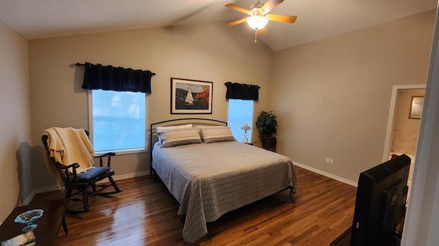 bedroom with lofted ceiling, dark hardwood / wood-style floors, and ceiling fan