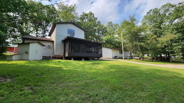 43 Dale Dr, Kimberling City, MO 65686 - back of property featuring a storage shed, a lawn, an outbuilding, and a sunroom