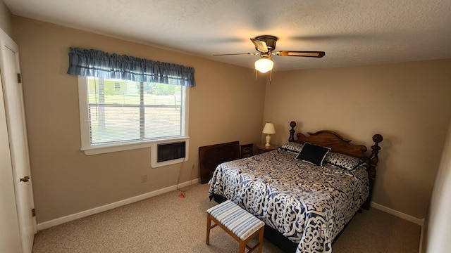 carpeted bedroom featuring a textured ceiling and ceiling fan