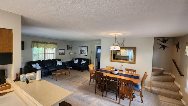 carpeted dining area featuring a textured ceiling