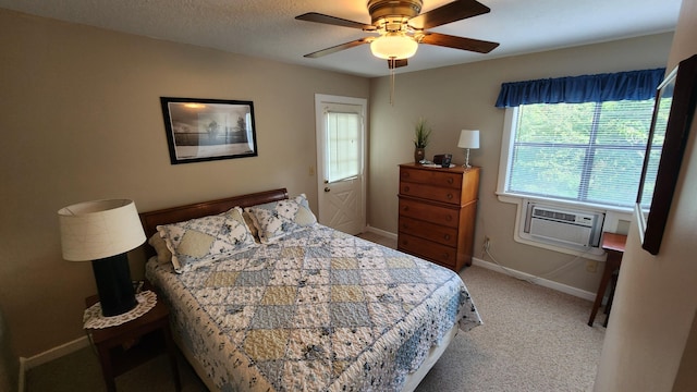 bedroom with a textured ceiling, cooling unit, ceiling fan, and carpet flooring