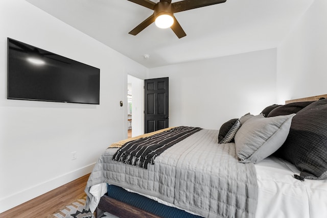 bedroom with ceiling fan and hardwood / wood-style flooring