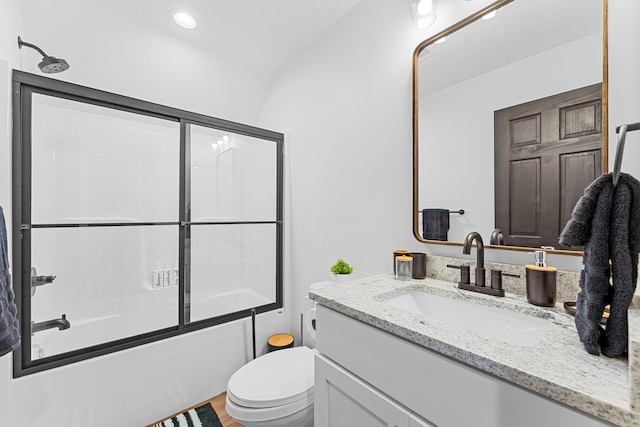 full bathroom with bath / shower combo with glass door, vanity, and toilet