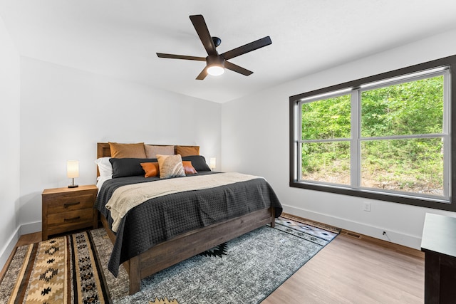 bedroom with wood-type flooring and ceiling fan