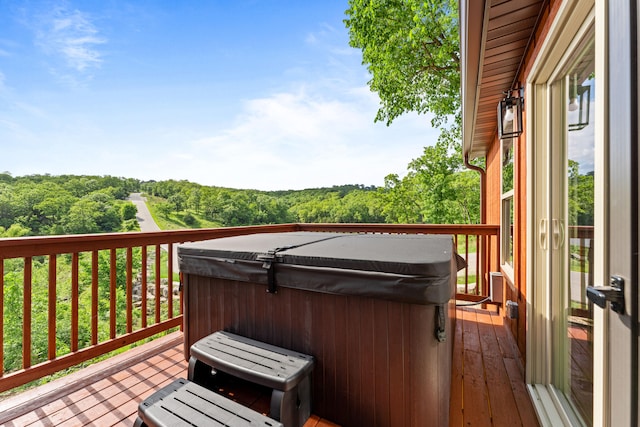 wooden deck featuring a hot tub