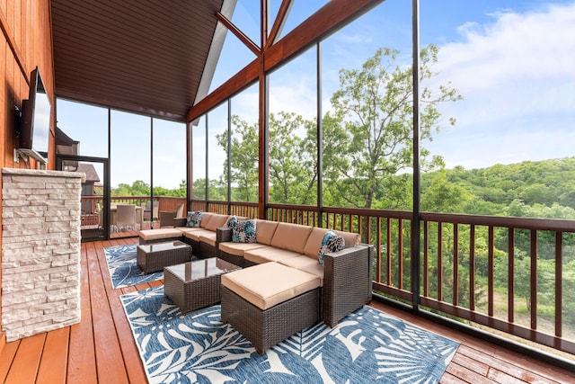 sunroom / solarium featuring lofted ceiling