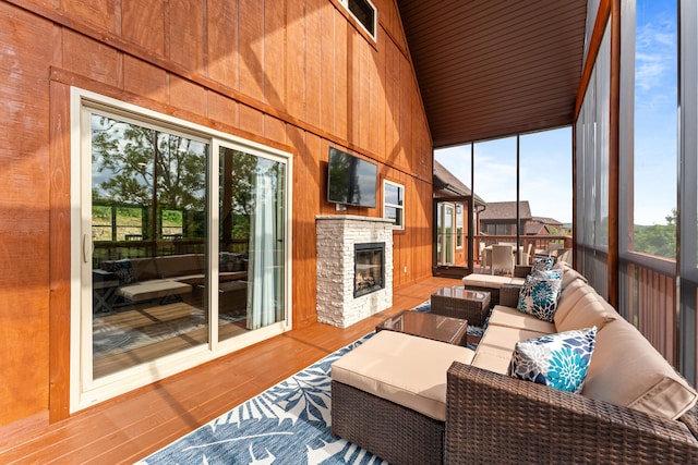 sunroom / solarium with a fireplace, vaulted ceiling, and wooden ceiling