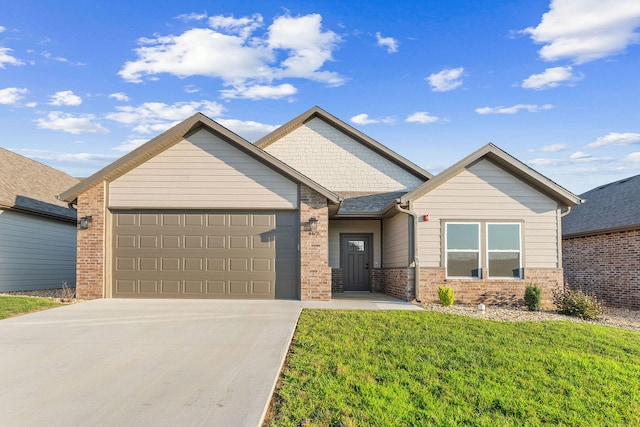 view of front of home with a garage and a front lawn