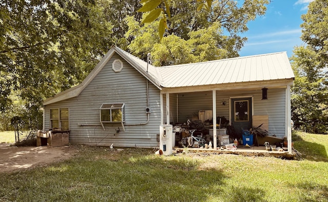 back of property featuring a yard