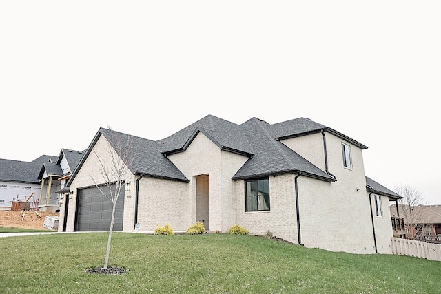 view of front of house with a garage and a front yard