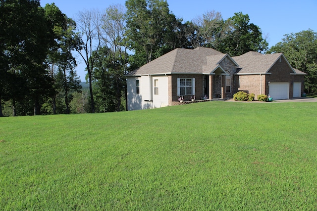 view of front of home with a garage and a front yard