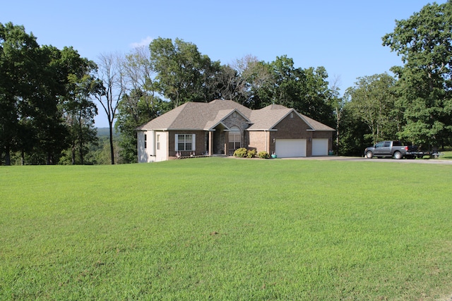 ranch-style home with a garage and a front lawn