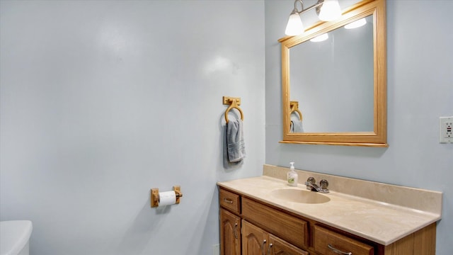 half bathroom featuring toilet and vanity