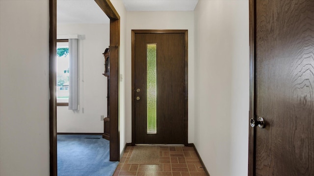 foyer featuring baseboards