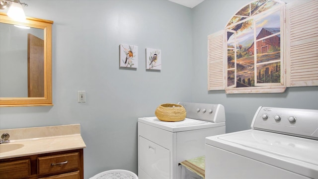 washroom with washer and dryer and a sink