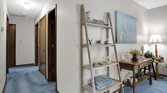 hall featuring carpet and visible vents