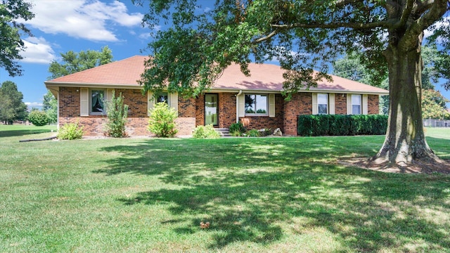 ranch-style house featuring brick siding and a front yard