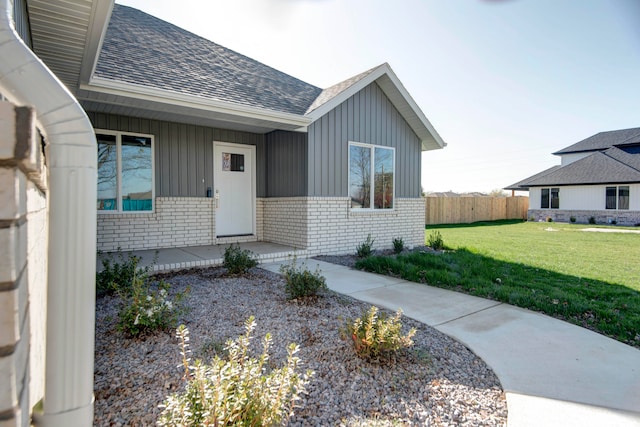 property entrance with a yard