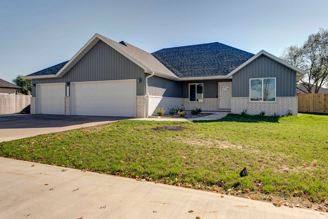 view of front of property with a garage and a front yard