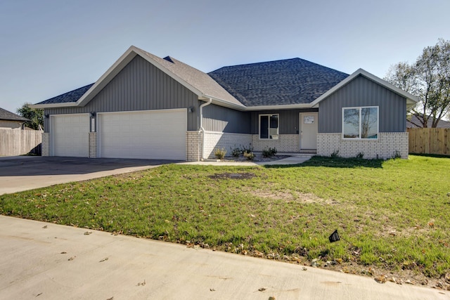 3668 W Overland St, Springfield, MO 65807 - single story home featuring a shingled roof, a garage, brick siding, board and batten siding, and concrete driveway