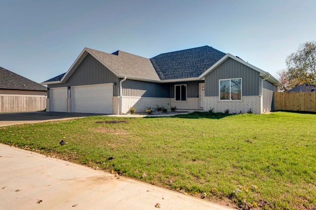 view of front of property with a garage and a front yard