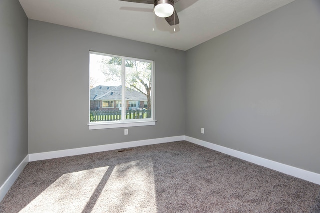 carpeted spare room with ceiling fan